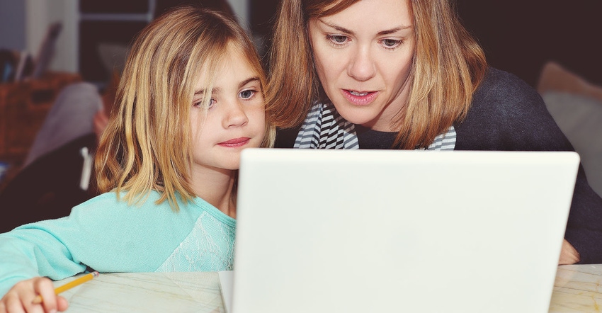 Mom with her young daughter using a laptop computer to do homework.