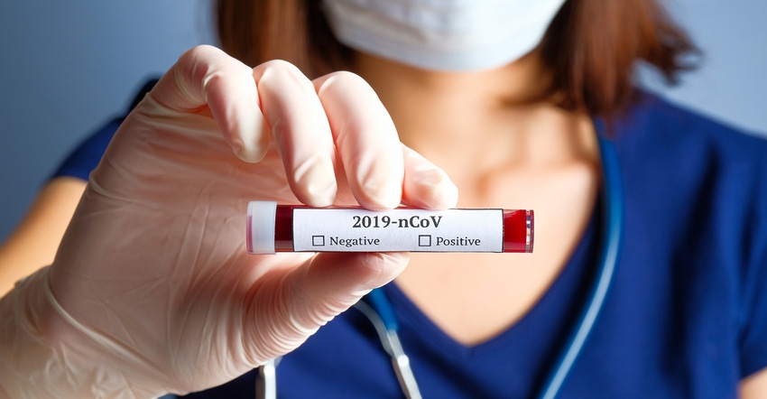 Female nurse holding a Covid-19 vial