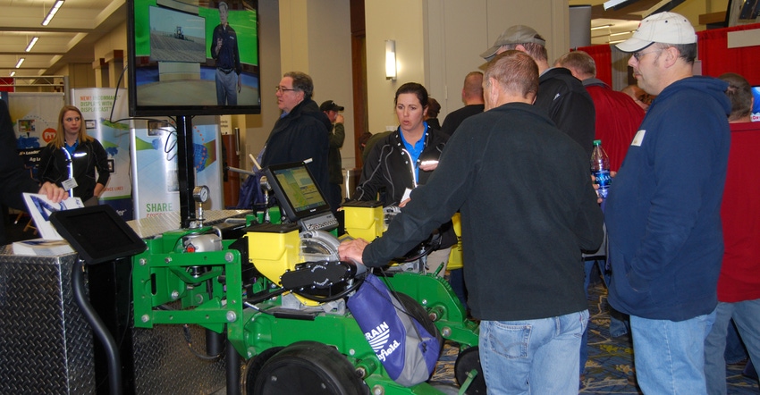 Visitors watch an equipment demo at the Iowa Power Farming Show
