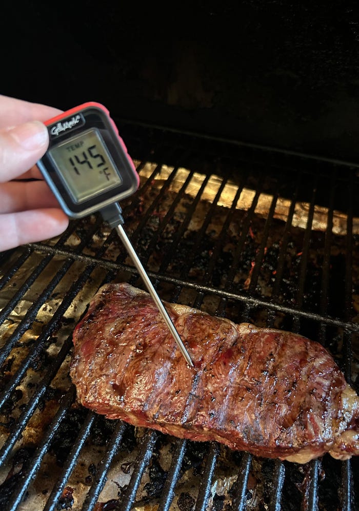 meat on grill with thermometer
