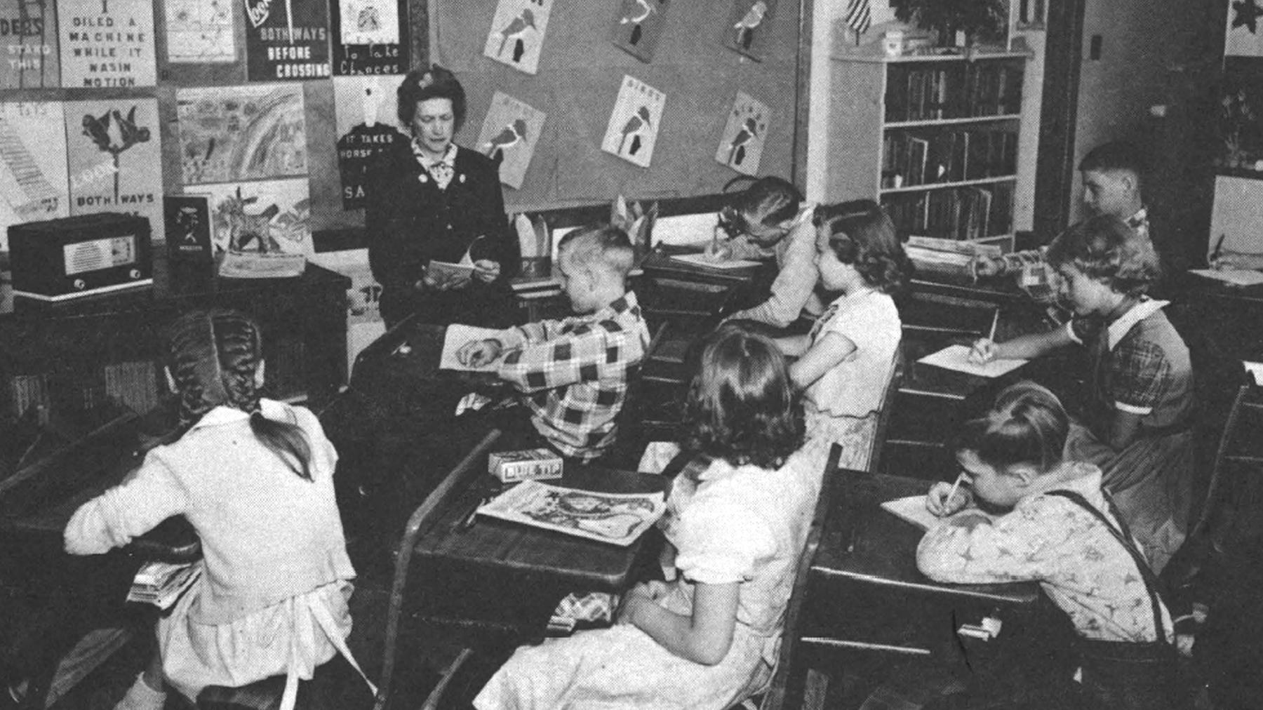 old photo of students and their teacher in a one-room school