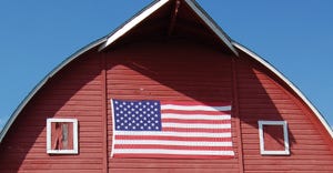 red barn with American flag painted on it