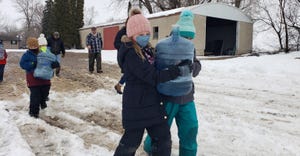 children carrying jugs during winter