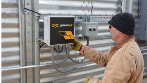 Tom Nugent examines the control box for his GSI GrainVue system