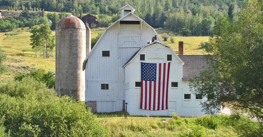 U.S. flag on side of white barn