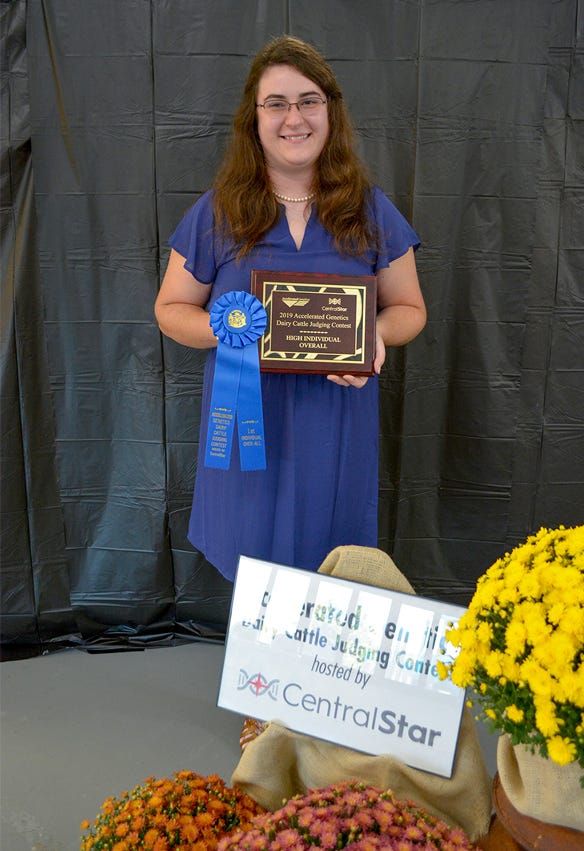 Allison Schafer of Westphalia, Mich.holding blue ribbon and plaque