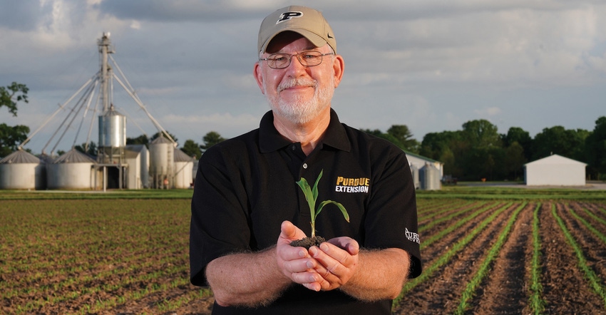Bob Nielsen holding corn plant