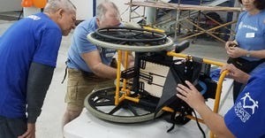 Randy Overman helps repair a wheelchair