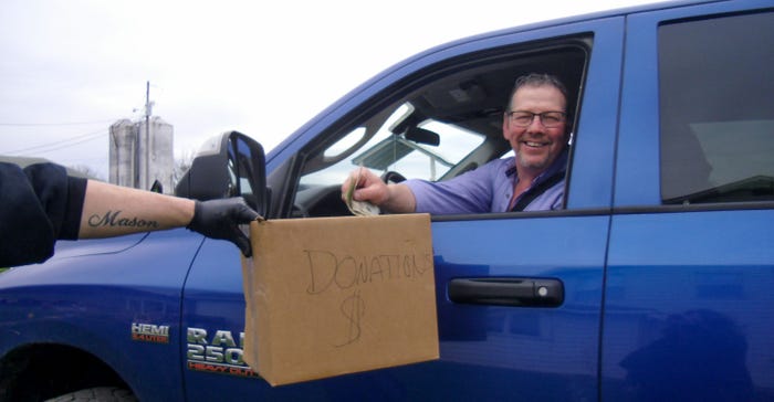 A drivers participating in the drive-thru dairy donates money to help cover the costs of buying milk and other products