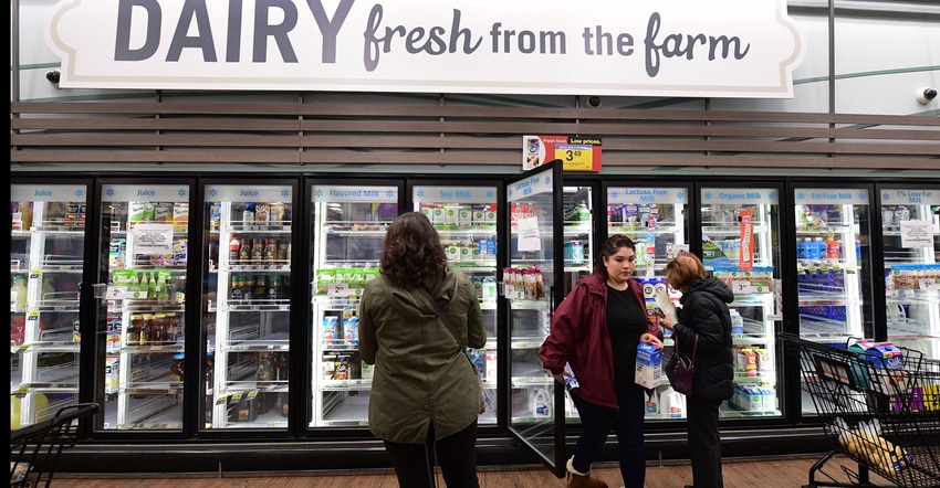 People shop for dairy products at a supermarket / DAIRY CONSUMPTION: Nearly half of all cheese in the U.S. is purchased by fo People shop for dairy products at a supermarket / DAIRY CONSUMPTION: Nearly half of all cheese in the U.S. is purchased by fo