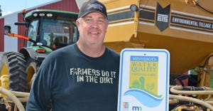 Greg Entinger holds sign from MDA Ag Water Quality Certification Program