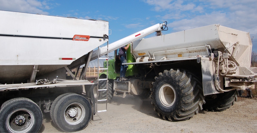 auger filling truck to apply fertilizer