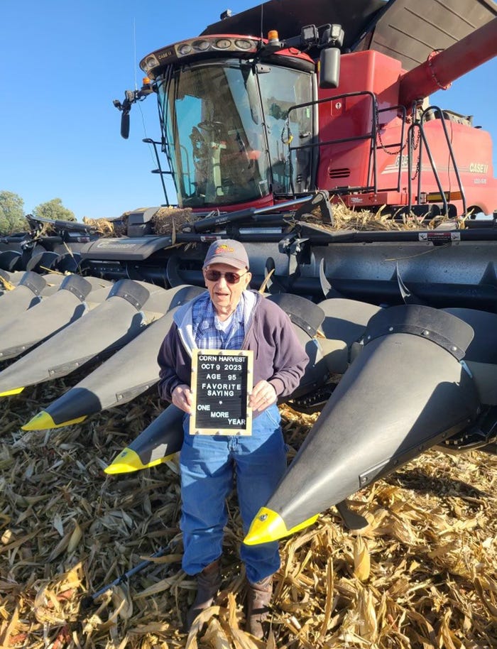 Bob Pflughaupt in front of tractor with corn heads