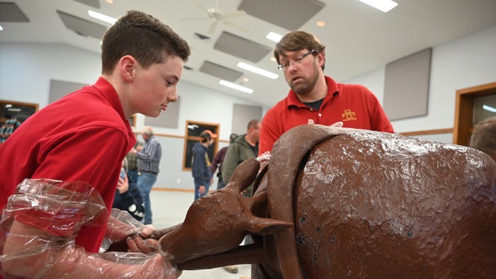 teen boy helping with simulated calf birth