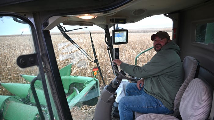 Farmer sitting in tractor cab