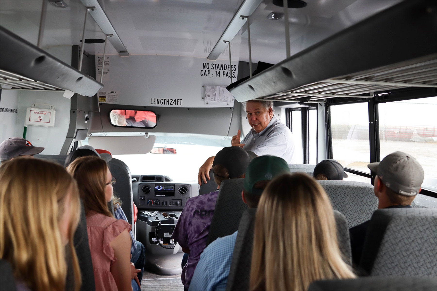 Dave Duzan, Illinois Beef Association president speaking to a bus full of people