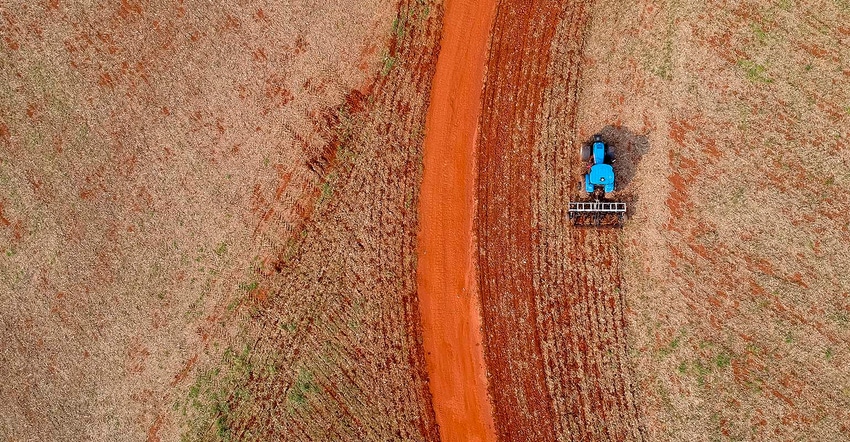 Tractor harrowing the soil to plant soybeans in Brazil