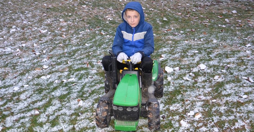 10-year-old Graham riding on tiny John Deere tractor