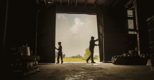 farmer and son opening barn doors