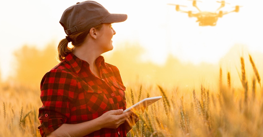 farmer controls drone with a tablet