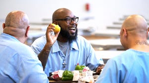 Prison resident eating a pear