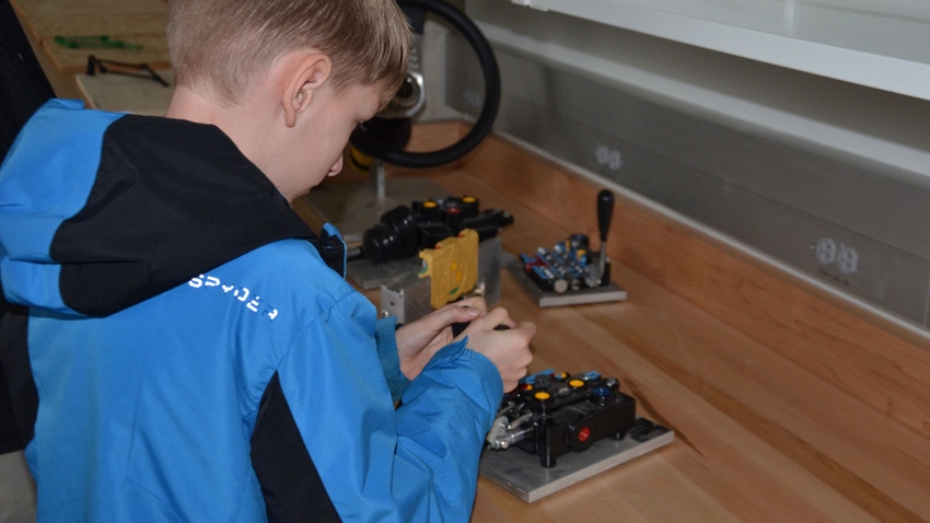 young boy plays with electronics