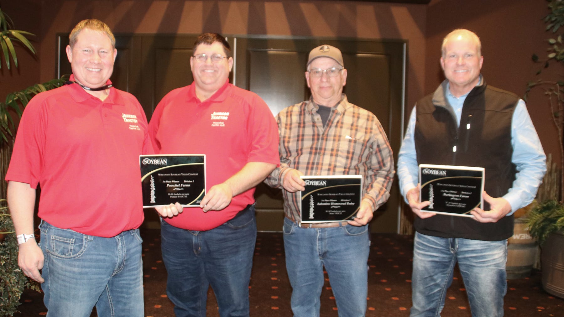 Todd and T.J. Poeschel, Jim Salentine, and Tom Evanstad holding plaques