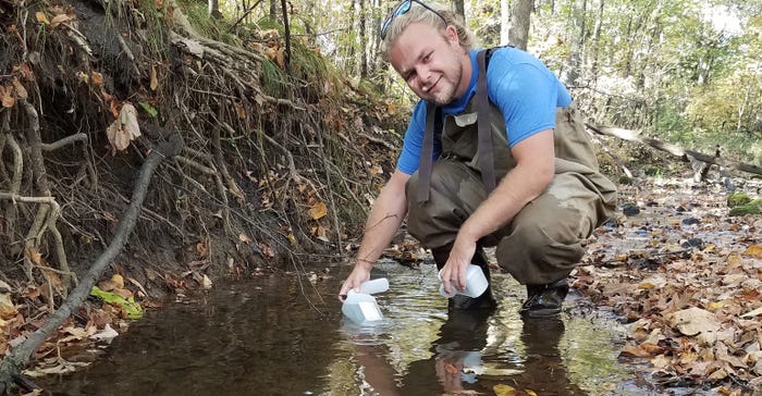 Dane McKittrick collects a water sample