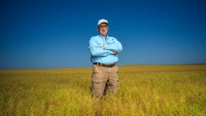 Eric Boeck stands in field with crossed arms