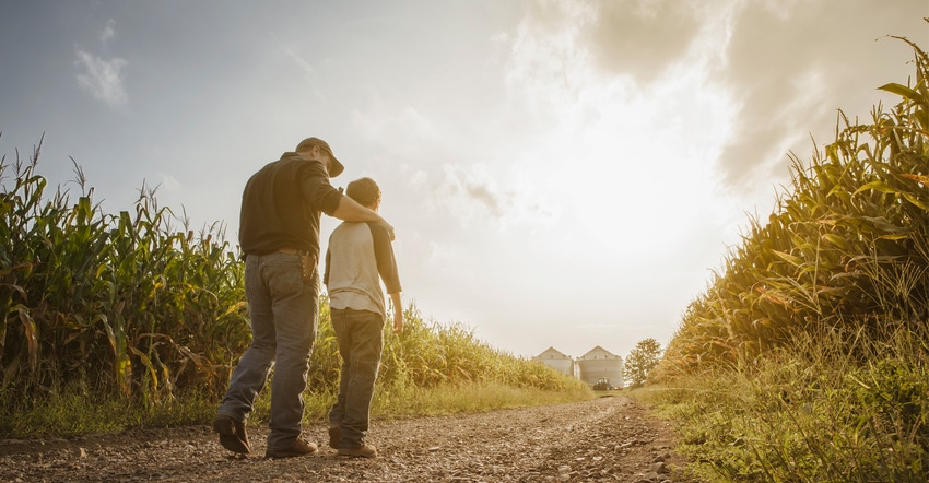 Father and son walking on a dirt road