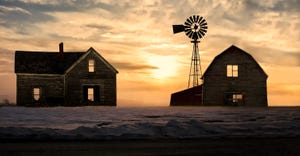 house, wind vane and barn at sunset