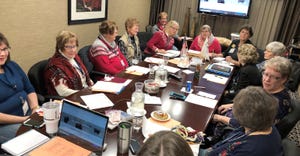 women of Minnesota Cattlewomen’s organization hold a meeting around a table