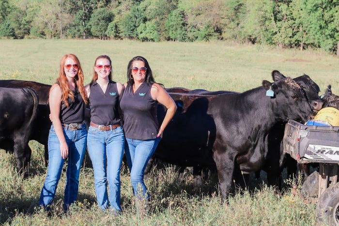 Macey Hurst, sister Emma Hurst Kipphut and mom Staci Hurst stand in a field with cattle