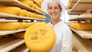 Maartje Murphy, holding large round Gouda cheese