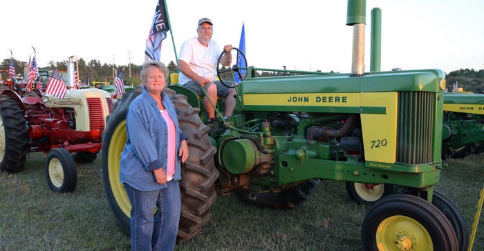 Pam Vaillancourt and Nate Richardson with their vintage John Deere tractor