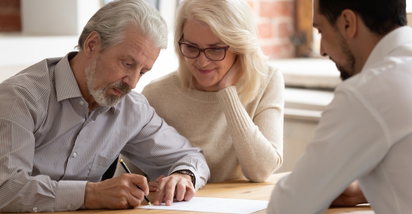 mature couple filling out paperwork