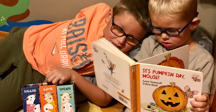 A boy reading to his younger brother