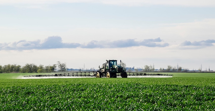 spraying fertilizer on farm field