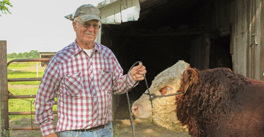 Ted Hunt standing with a cow