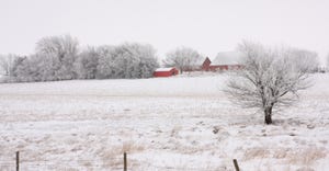 Farm house, barn and snow covered field