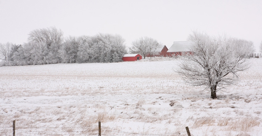 Farm house, barn and snow covered field