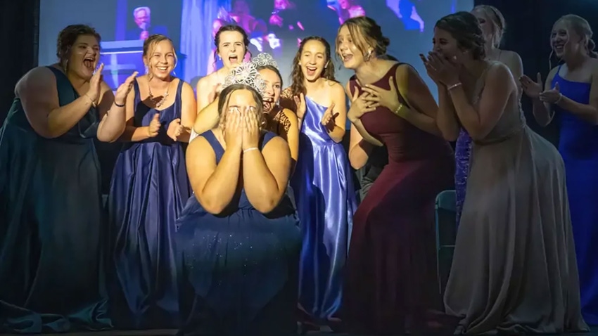 group of women in pageant dresses celebrating pageant winner