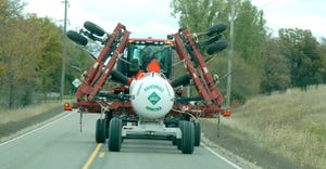anhydrous tank behind a tractor on highway