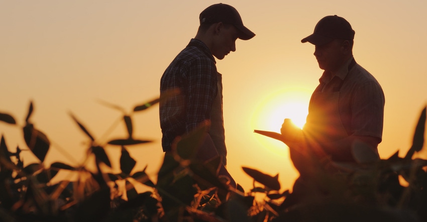 Farmers in field with tablet