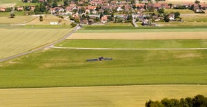aerial view of drone flying over a field and town