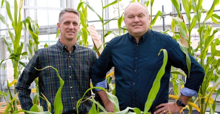 Todd Krone, left, and Jason Cope, founders of PowerPollen, standing in greenhouse