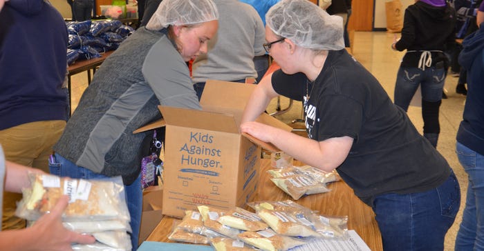 students packing food boxes