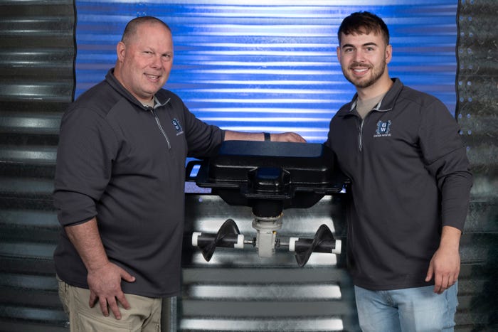 two men smiling with grain weevil robot