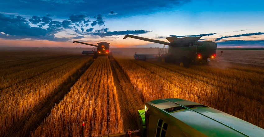 Combines working at twilight during the wheat harvest