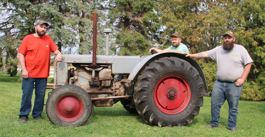 Brothers Michael, Carl and Adam Endres with vintage 1935 Case C tractor 